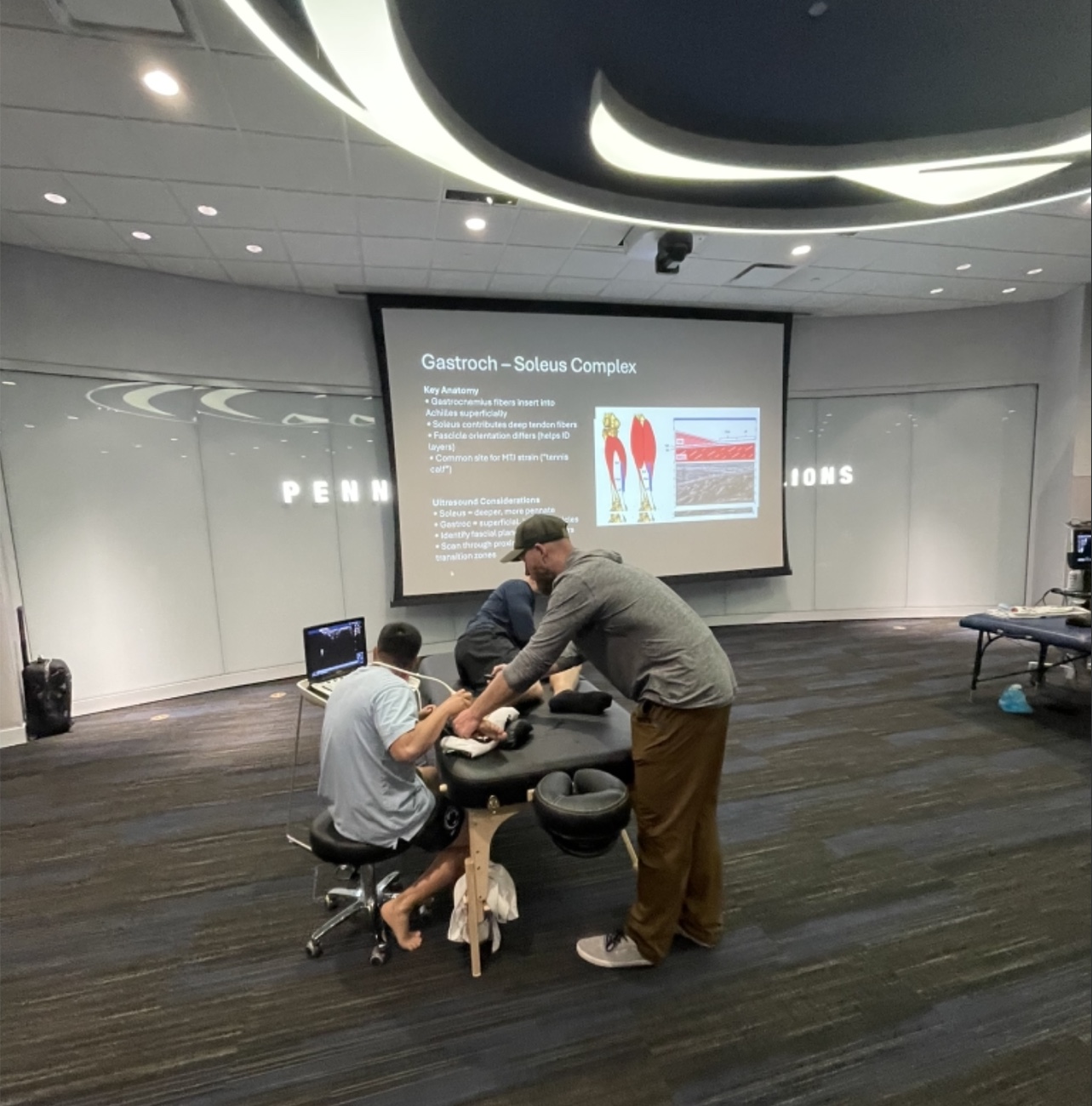 Clinicians practicing lower-leg ultrasound scanning during a hands-on Pura Health workshop